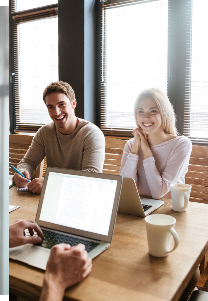 three-young-cheerful-colleagues-work-with-laptops